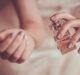 bride applying perfume on her wrist