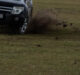 Offroad suv Mitsubishi pajero running on mountain valley throwing away dirt and soil under wheels. Summer road trip. Acceleration speed motion. Off-road car speed. 09.08.2021 Almaty, Kazakhstan.